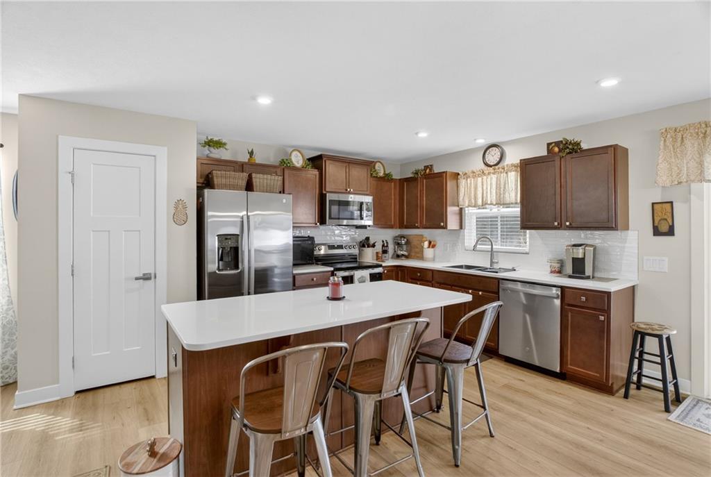 105 Horseshoe Loop Washington, PA 15301 - Photo 16 of 49 a kitchen with stainless steel appliances granite countertop a table chairs refrigerator and microwave