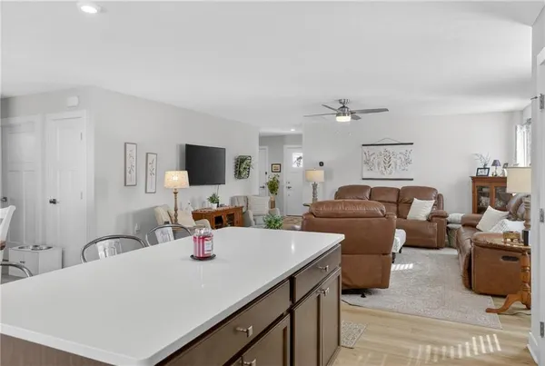 a large white kitchen with a stove a sink dishwasher and a microwave oven with cabinets