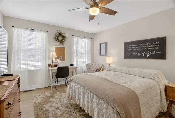 a bedroom with a bed and a lamp