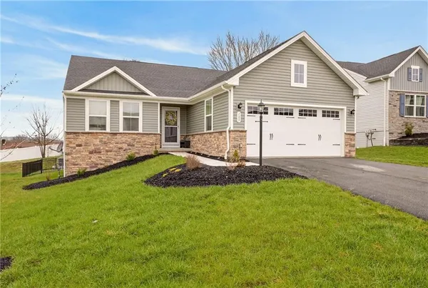 a view of a house with a yard and patio