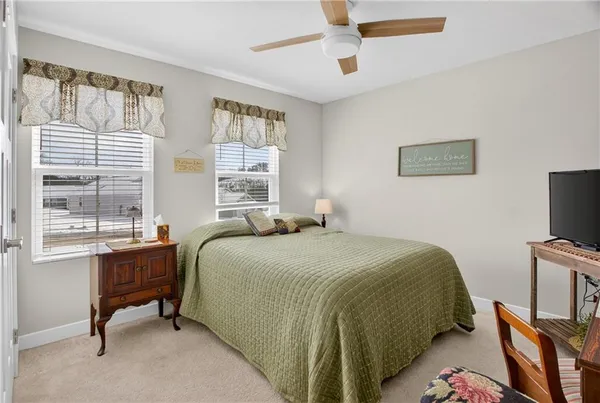 a bedroom with a large bed and a large window