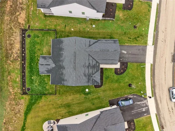 an aerial view of a house with garden space and houses