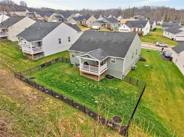 an aerial view of residential house with outdoor space and a lake view