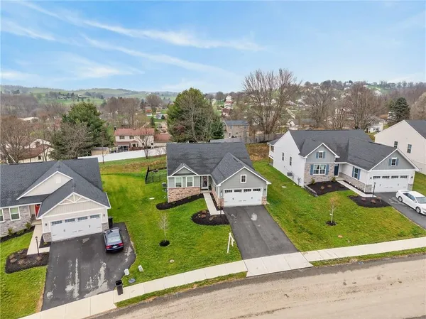 an aerial view of residential houses with outdoor space