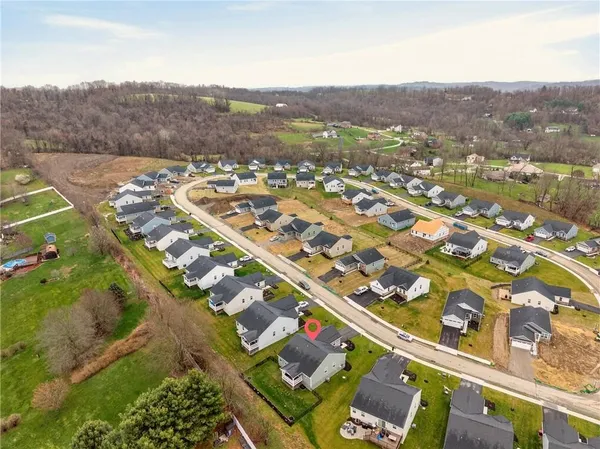 an aerial view of residential houses with outdoor space