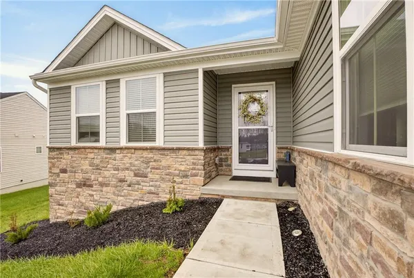 a view of a brick house with large windows
