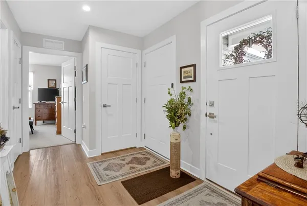 a view of room with wooden floor and bathroom