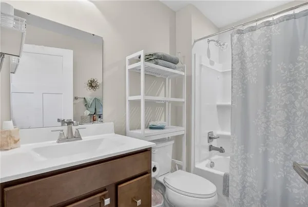 a bathroom with a sink toilet vanity and shower