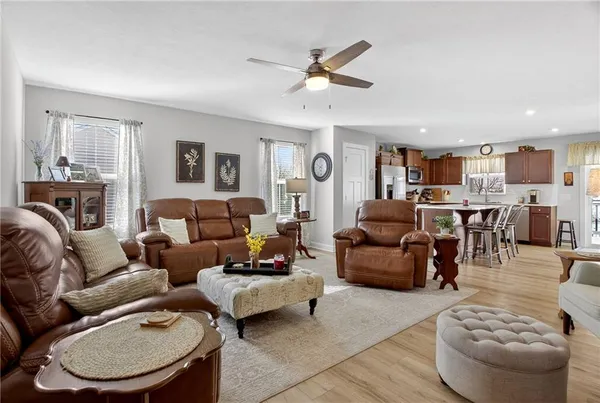 a living room with furniture and a view of kitchen
