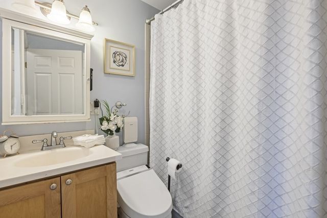 a bathroom with a toilet a sink and a mirror