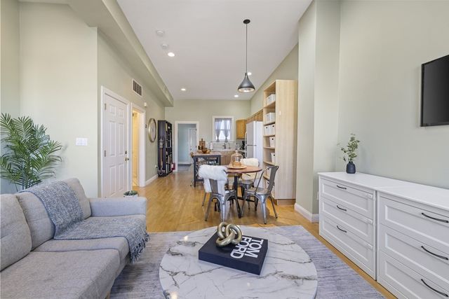 a living room with furniture and a chandelier