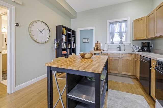 a kitchen with a table chairs sink and cabinets