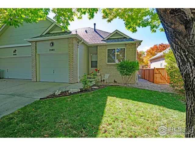 a front view of a house with a garden and plants