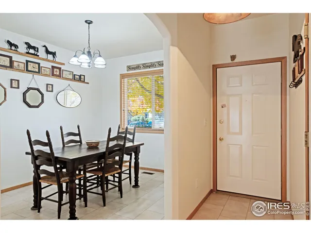 a view of a dining room with furniture and chandelier