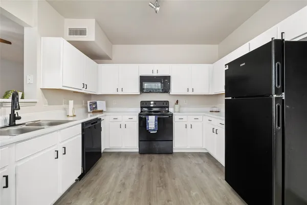 a kitchen with a refrigerator stove and sink