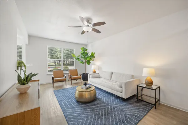 a living room with furniture and a potted plant