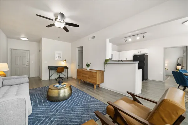 a living room with furniture and wooden floor
