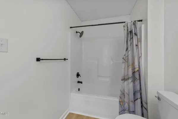 a bathroom with a shower and a toilet
