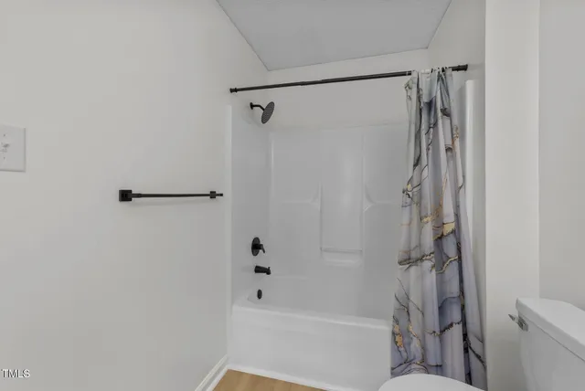 a bathroom with a shower and a toilet