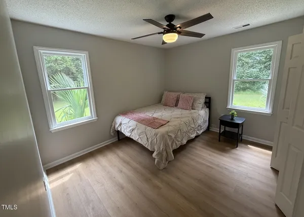 a bed sitting in a bedroom next to a window