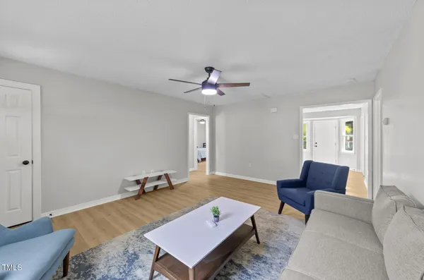 a living room with furniture and a chandelier
