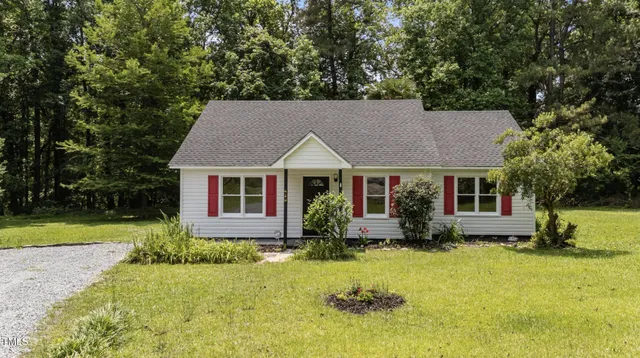 a aerial view of a house next to a yard