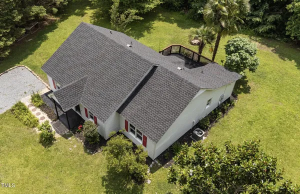 an aerial view of a house with a yard and lake view