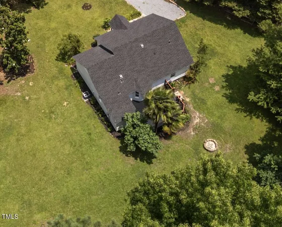 an aerial view of a house with a yard
