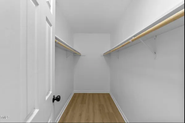 a view of a room with wooden floor and white walls