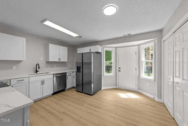 a kitchen with a refrigerator and a sink