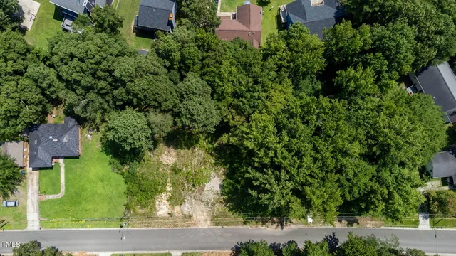 an aerial view of a house with a yard and fountain
