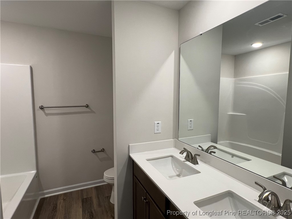 528 Traveller Way Raeford, NC 28376 - Photo 14 of 23 a bathroom with a sink and a mirror