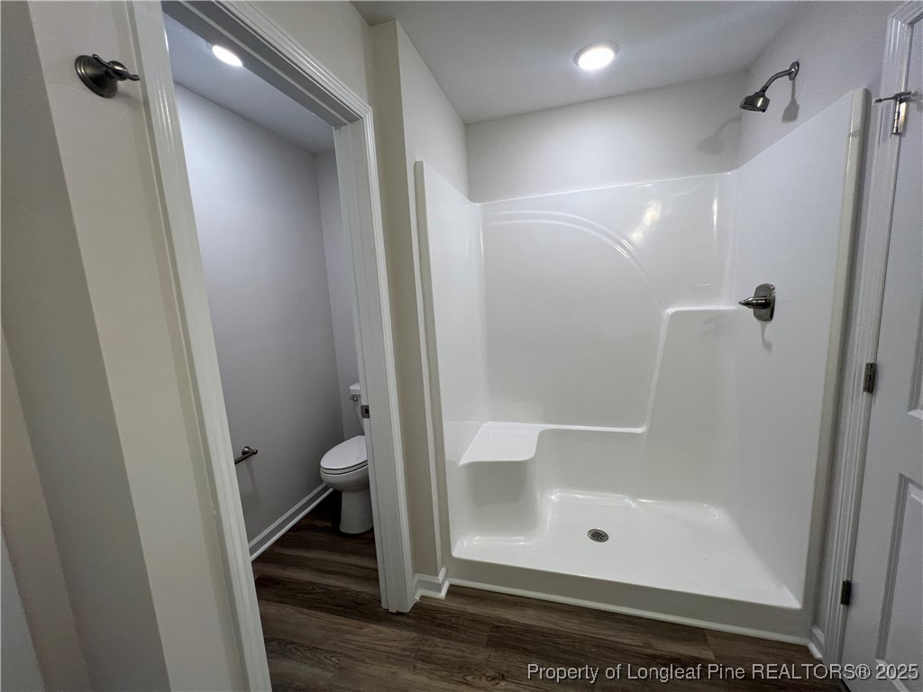 528 Traveller Way Raeford, NC 28376 - Photo 20 of 23 a bathroom with a glass door shower a toilet and a sink