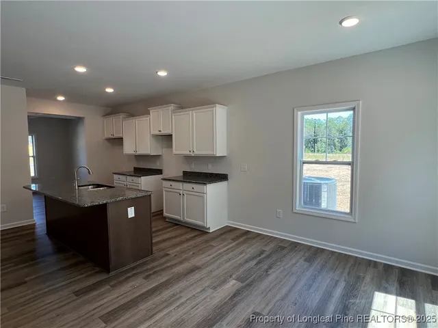 a kitchen with granite countertop a stove and a refrigerator