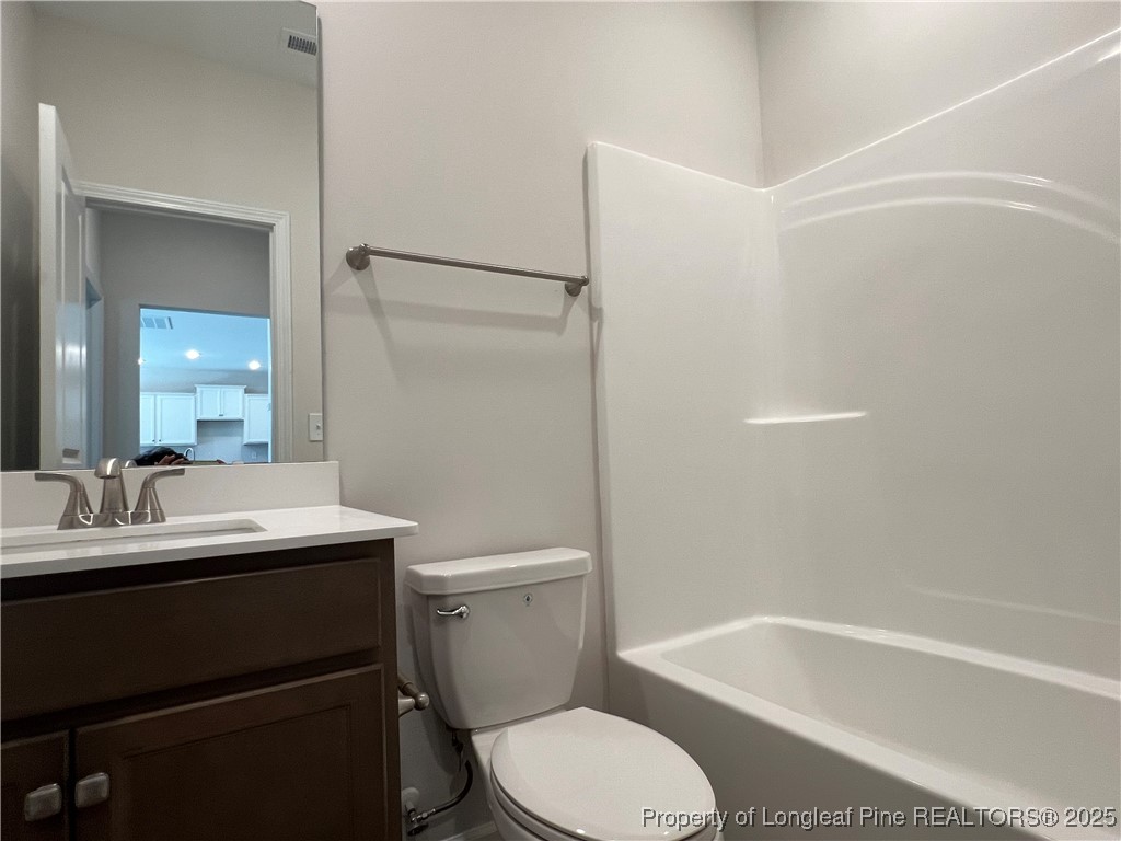 528 Traveller Way Raeford, NC 28376 - Photo 10 of 23 a bathroom with a sink toilet and shower