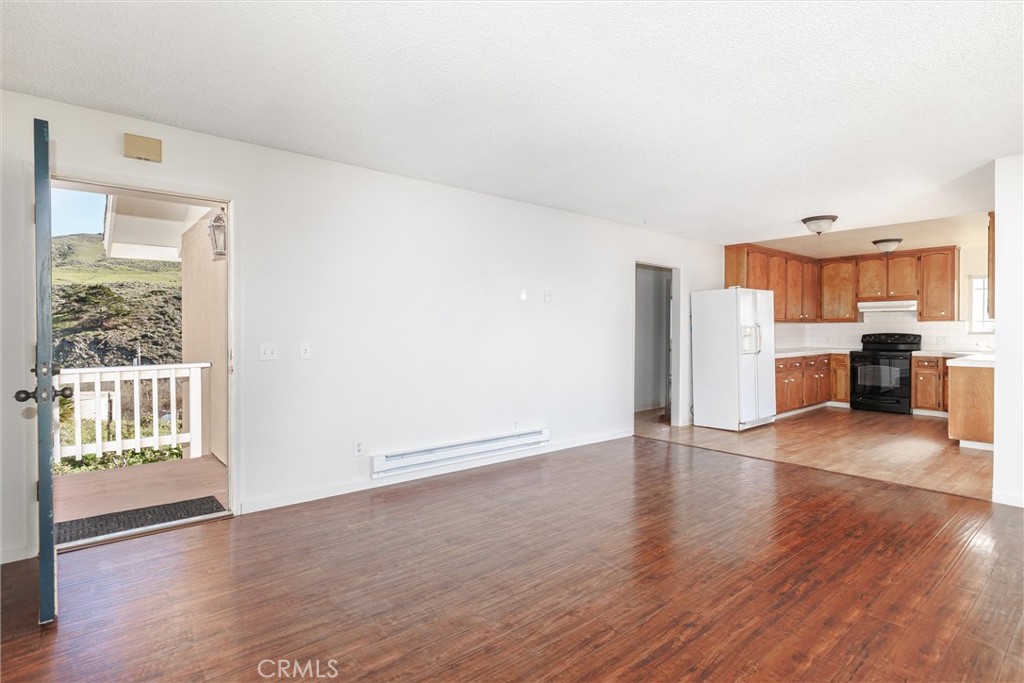 2023 Circle Cayucos, CA 93430 - Photo 21 of 44 a view of a kitchen with a refrigerator a stove top oven and cabinets