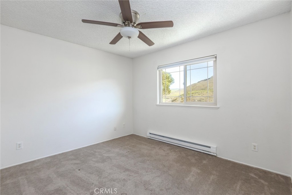 2023 Circle Cayucos, CA 93430 - Photo 24 of 44 an empty room with a window and ceiling fan