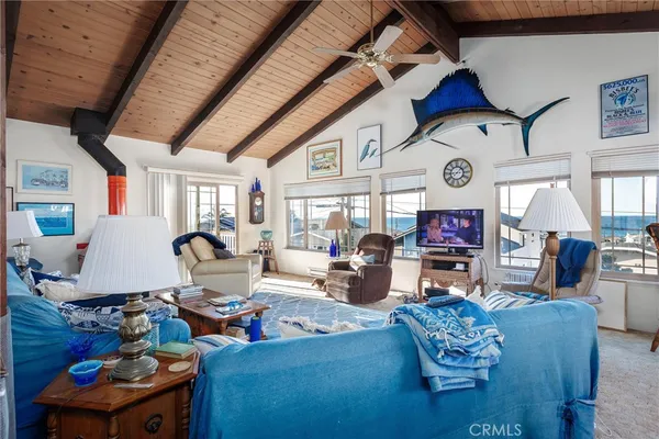 a living room with fireplace furniture and a large window