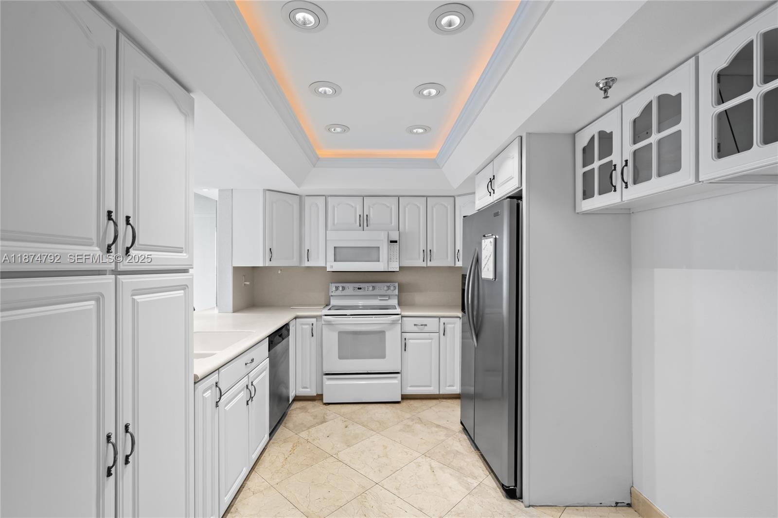 520 Brickell Key Drive, Unit A705 Miami, FL 33131 - Photo 13 of 63 a kitchen with cabinets and stainless steel appliances