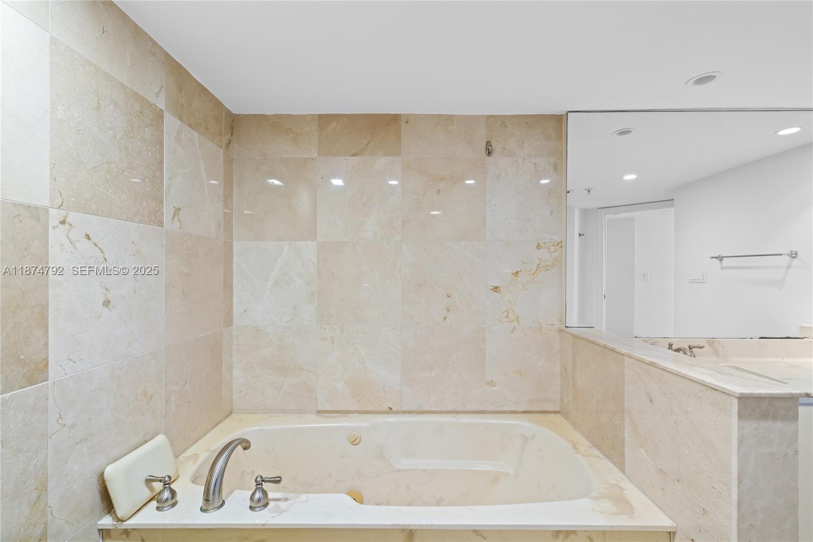 520 Brickell Key Drive, Unit A705 Miami, FL 33131 - Photo 37 of 63 a bathroom with a bathtub and a shower