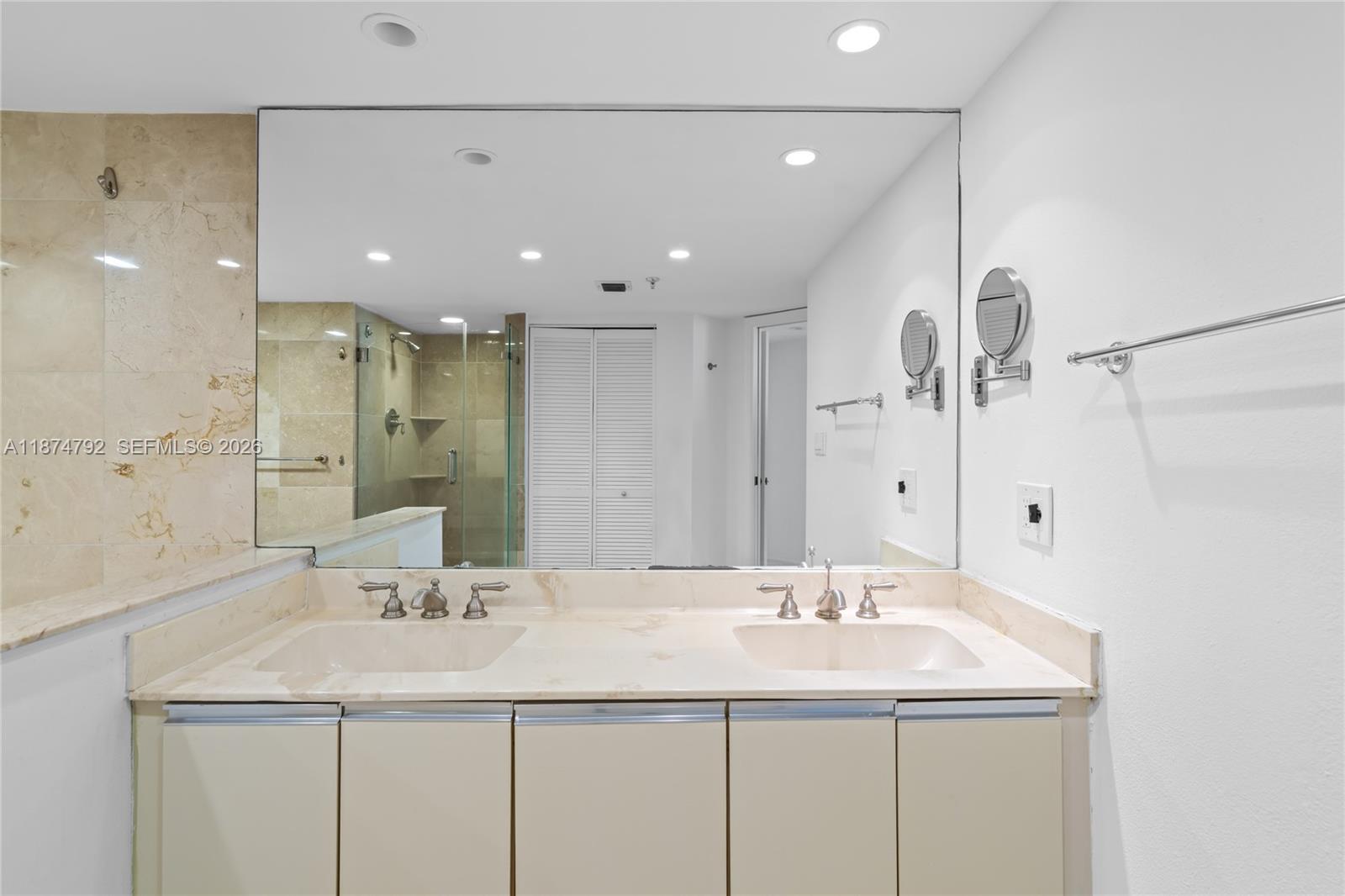 520 Brickell Key Drive, Unit A705 Miami, FL 33131 - Photo 40 of 63 a bathroom with a sink and a mirror