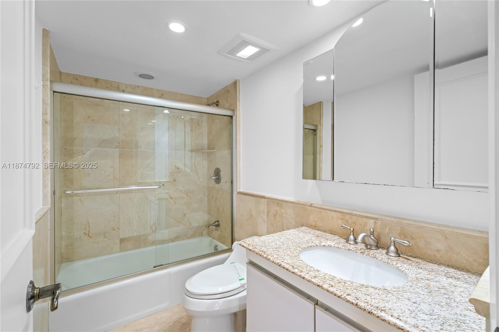 520 Brickell Key Drive, Unit A705 Miami, FL 33131 - Photo 48 of 63 a bathroom with a granite countertop sink toilet and shower