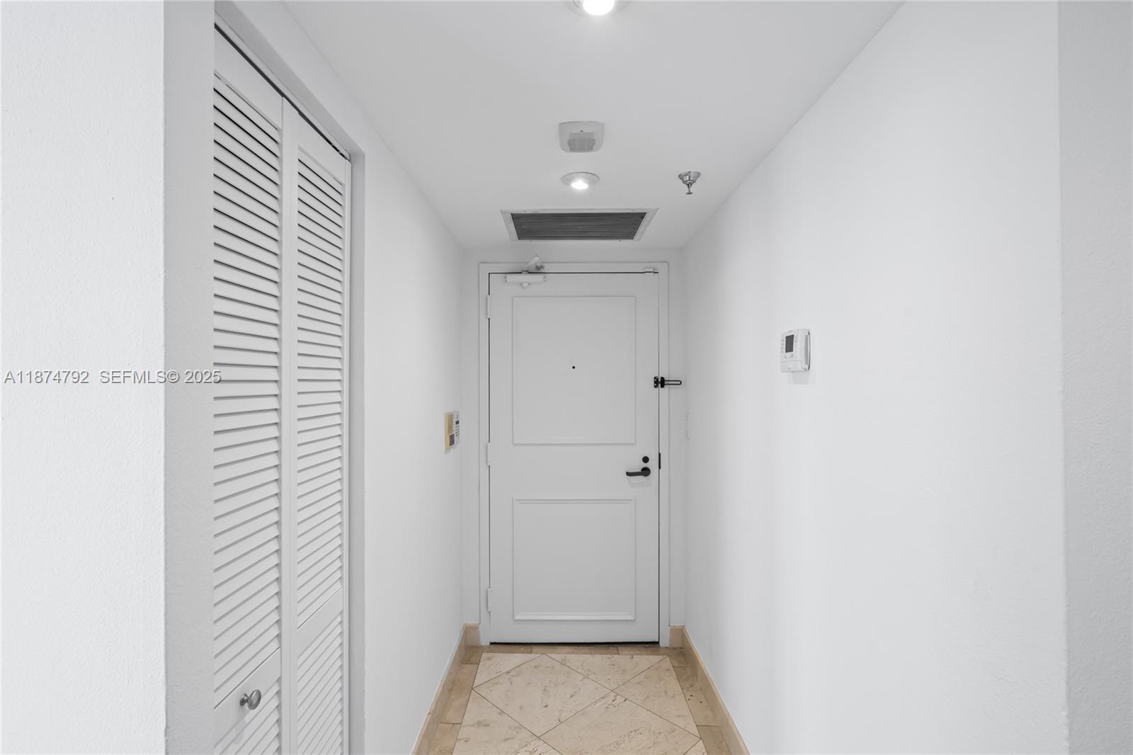 520 Brickell Key Drive, Unit A705 Miami, FL 33131 - Photo 50 of 63 a view of a hallway with a white door