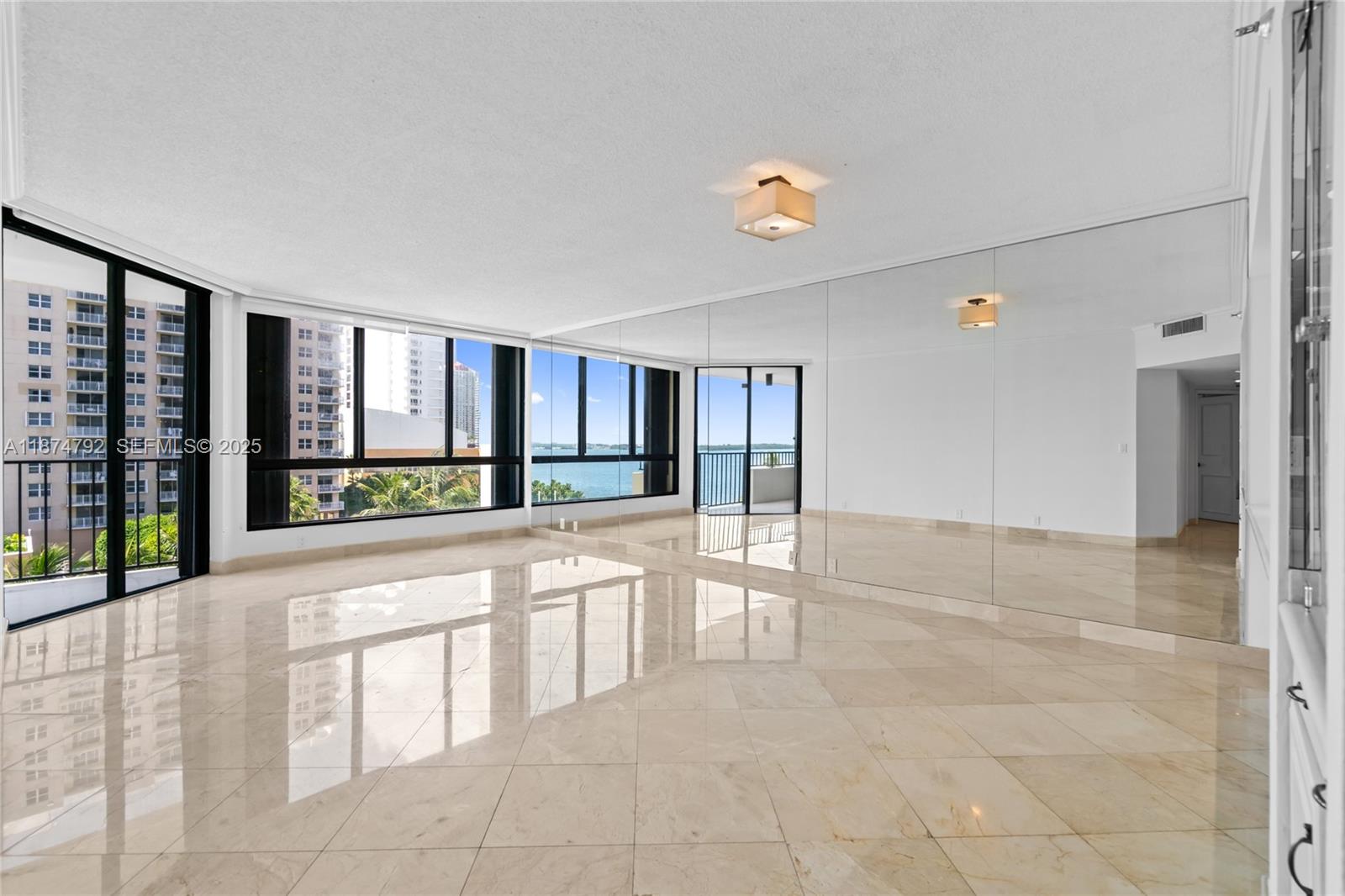 520 Brickell Key Drive, Unit A705 Miami, FL 33131 - Photo 10 of 63 a view of an entryway with a floor to ceiling window and an empty room