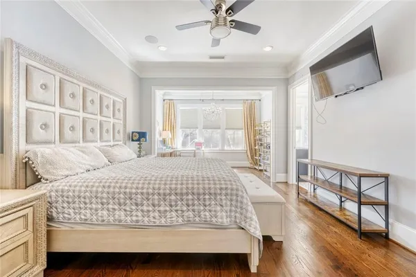 a bedroom with a large bed and a chandelier