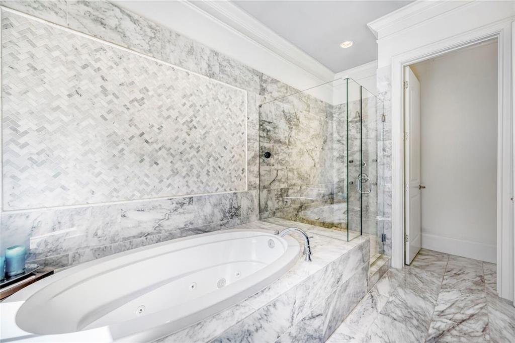 1196 John Collier Road Northwest, Unit 1196 Atlanta, GA 30318 - Photo 16 of 26 a bathroom with a bathtub and a shower