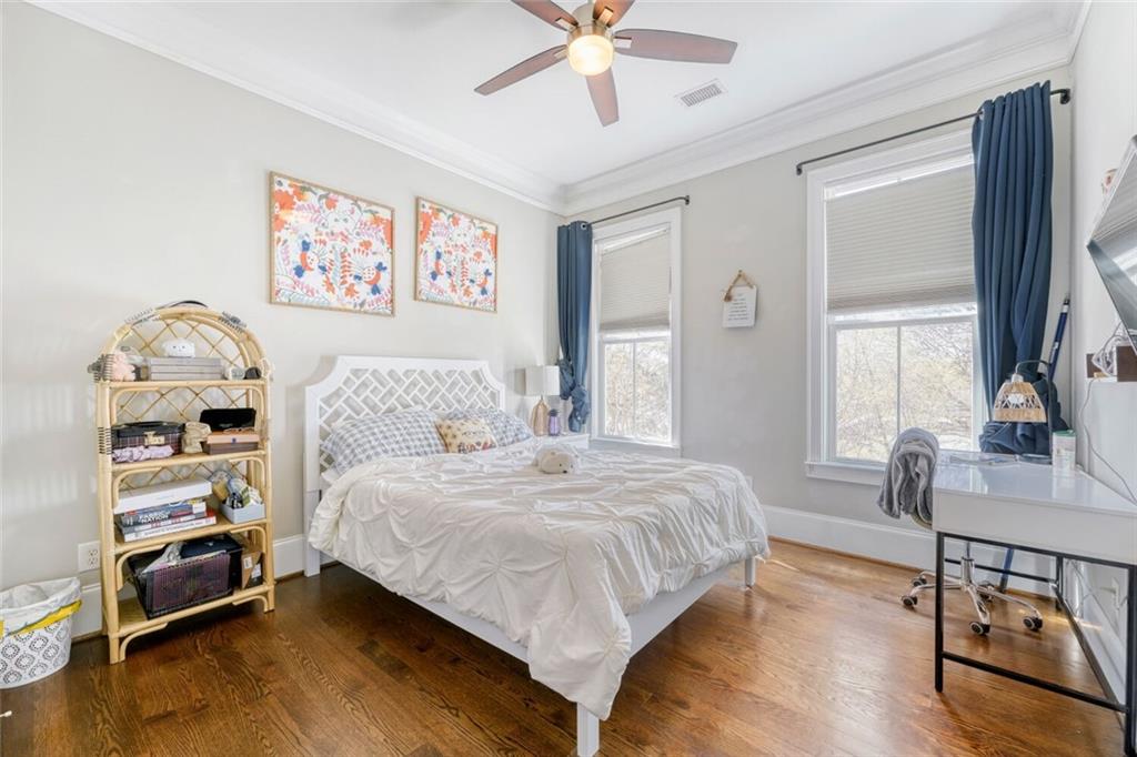 1196 John Collier Road Northwest, Unit 1196 Atlanta, GA 30318 - Photo 18 of 26 a bedroom with a bed and a chandelier