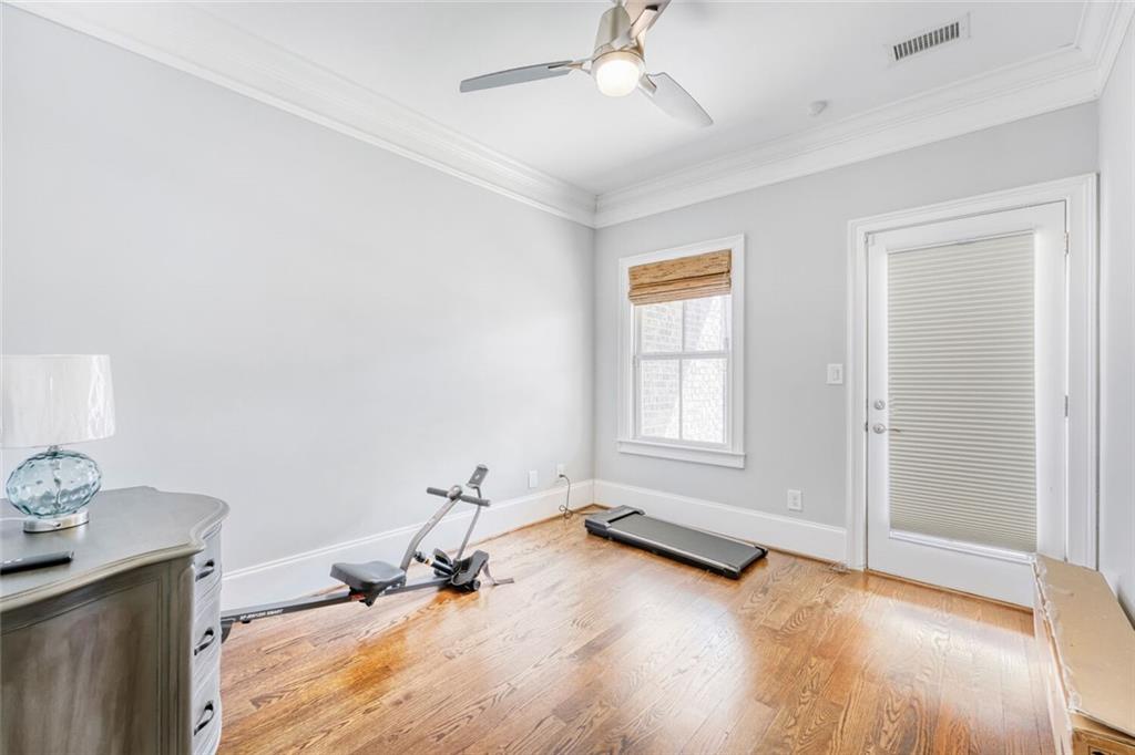 1196 John Collier Road Northwest, Unit 1196 Atlanta, GA 30318 - Photo 21 of 26 a view of a room with gym equipment and wooden floor