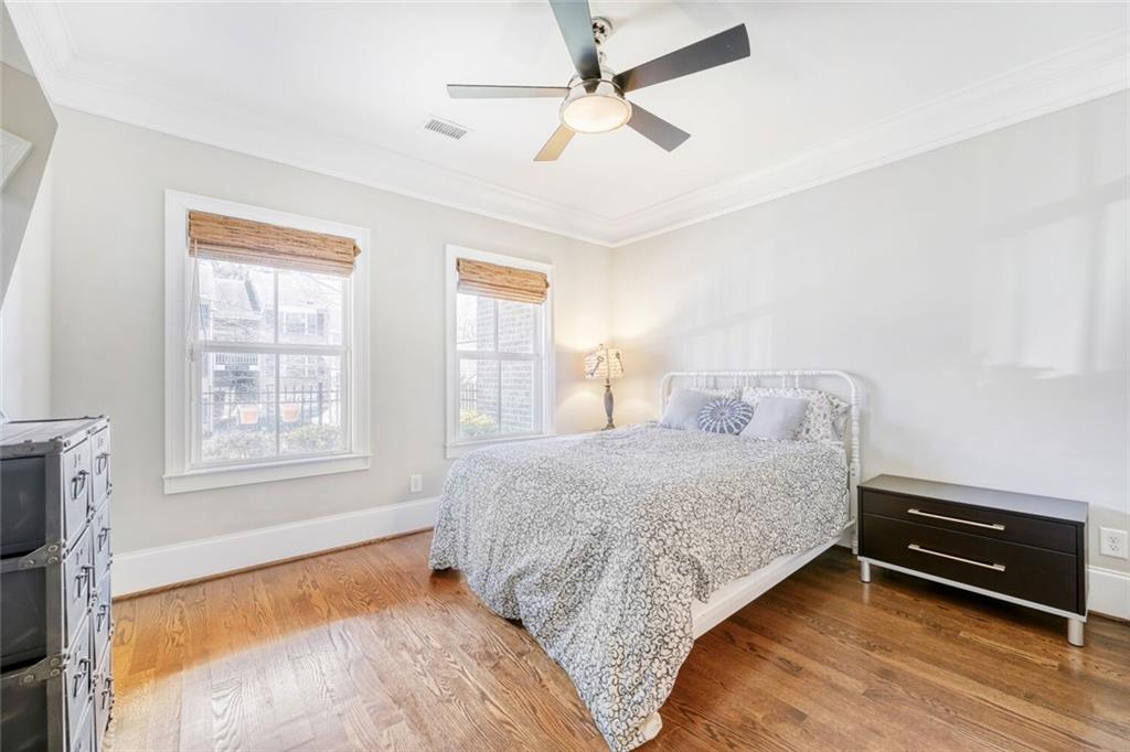 1196 John Collier Road Northwest, Unit 1196 Atlanta, GA 30318 - Photo 22 of 26 a bedroom with a bed dresser and a window