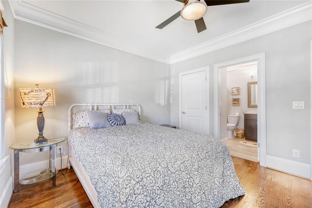 1196 John Collier Road Northwest, Unit 1196 Atlanta, GA 30318 - Photo 23 of 26 a bedroom with a bed and wooden floor